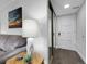 Cozy living room featuring wood floors, mirrored closet, and a comfortable seating area at 7318 S Xenia Cir # B, Centennial, CO 80112