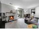 Comfortable living room with stone fireplace, plush carpet, and access to the outdoors at 7318 S Xenia Cir # B, Centennial, CO 80112
