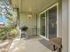 Relaxing outdoor patio space featuring a grill and small table near sliding glass doors at 7318 S Xenia Cir # B, Centennial, CO 80112