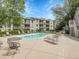 Resort-style community pool with numerous chairs and well-manicured grounds at 7318 S Xenia Cir # B, Centennial, CO 80112