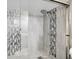 Close-up of the shower with stylish tilework and modern fixtures at 7318 S Xenia Cir # B, Centennial, CO 80112