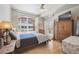 Bright bedroom featuring a large window, shutters, and hardwood flooring at 1100 Cherokee St # 304, Denver, CO 80204