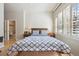 Serene bedroom with a big window, shutters, and hardwood flooring at 1100 Cherokee St # 304, Denver, CO 80204