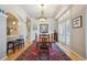 Elegant dining room with stylish chandelier, long wood table, and large shuttered windows at 1100 Cherokee St # 304, Denver, CO 80204