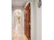 Foyer with a wood front door leading to a bright kitchen with stone floors at 1100 Cherokee St # 304, Denver, CO 80204