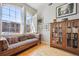 Cozy living room featuring a large window, shutters, and hardwood flooring at 1100 Cherokee St # 304, Denver, CO 80204
