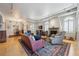 Bright living room featuring a fireplace, shutters, hardwood floors, and stylish furniture at 1100 Cherokee St # 304, Denver, CO 80204