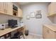 Functional office space with built-in desk, cabinets, and tile flooring at 1100 Cherokee St # 304, Denver, CO 80204