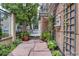 Stone walkway leading to entrance with lush greenery and decorative elements at 1100 Cherokee St # 304, Denver, CO 80204