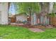 Charming backyard features a colorful shed, patio seating, and mature tree at 32 Powder Horn Pl, Longmont, CO 80504