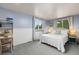 Bright bedroom with large windows and soft blue walls at 32 Powder Horn Pl, Longmont, CO 80504