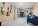 Bright bedroom with two windows, light grey carpet, a blue sofa and guitars displayed on wall at 32 Powder Horn Pl, Longmont, CO 80504