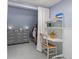 A bedroom features a gray dresser and an open closet and white shelving with a desk at 32 Powder Horn Pl, Longmont, CO 80504