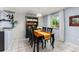 Charming dining room featuring a wooden table, decorative hutch, and bright natural light at 32 Powder Horn Pl, Longmont, CO 80504