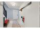 Welcoming entryway featuring a coat rack, bench, and bright, clean tile flooring at 32 Powder Horn Pl, Longmont, CO 80504
