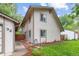 View of the home's exterior, including a detached garage, a well-maintained lawn, and neat landscaping at 32 Powder Horn Pl, Longmont, CO 80504