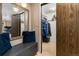 Hallway with wood-look floors, gray bench with mirror and closet at 32 Powder Horn Pl, Longmont, CO 80504