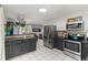 Open concept kitchen with stainless steel appliances, grey cabinets, and eat-in dining area at 32 Powder Horn Pl, Longmont, CO 80504