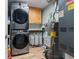 Laundry room features stacked washer and dryer and hot water heater at 32 Powder Horn Pl, Longmont, CO 80504