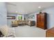 Inviting living room with a comfortable sectional sofa, a classic wooden cabinet, and ample natural light at 32 Powder Horn Pl, Longmont, CO 80504
