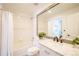 Well-lit bathroom features a large vanity mirror and shower-tub combo at 11606 Sagewood Ln, Parker, CO 80138