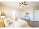 Spacious bedroom featuring a ceiling fan, ensuite bathroom, and ample storage space at 11606 Sagewood Ln, Parker, CO 80138