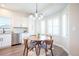Bright dining area with modern chandelier and stainless steel appliances in a cozy setting at 11606 Sagewood Ln, Parker, CO 80138