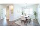 Dining room with modern light fixture, seating for six, and bright natural light at 11606 Sagewood Ln, Parker, CO 80138