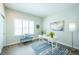 Bright office with large window, blue area rug, and modern white desk at 11606 Sagewood Ln, Parker, CO 80138