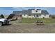 View of the back exterior and yard, with a truck parked at the end at 74500 E 136Th Ave, Byers, CO 80103