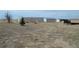 Two metal barns, a small tree and trailer are found on this property at 74500 E 136Th Ave, Byers, CO 80103