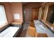 Bathroom featuring a soaking tub, double sink vanity, and separate glass-enclosed shower at 74500 E 136Th Ave, Byers, CO 80103