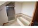Bathroom featuring a glass-enclosed shower and a neutral-toned bathtub at 74500 E 136Th Ave, Byers, CO 80103