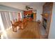 An open dining room area with stone fireplace and a view of the kitchen at 74500 E 136Th Ave, Byers, CO 80103