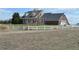Charming two-story home with a white fence and well-maintained lawn at 74500 E 136Th Ave, Byers, CO 80103