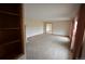 Bright living room with neutral carpet, large window, and built in shelving at 74500 E 136Th Ave, Byers, CO 80103