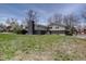 A spacious backyard with a view of the home's exterior, showing the lawn and mature trees at 6272 S Garfield Dr, Centennial, CO 80121