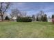 A spacious backyard featuring a well-maintained lawn and mature trees providing shade at 6272 S Garfield Dr, Centennial, CO 80121