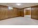 Finished basement area with paneled walls and neutral carpeting at 6272 S Garfield Dr, Centennial, CO 80121