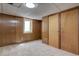 Finished basement area with paneled walls, neutral carpet, and closet at 6272 S Garfield Dr, Centennial, CO 80121