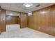 Basement area features paneled walls, neutral carpet, and entryways at 6272 S Garfield Dr, Centennial, CO 80121