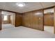 Basement area features paneled walls, neutral carpeting, and open doorway at 6272 S Garfield Dr, Centennial, CO 80121