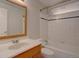 Updated bathroom features a tub shower, white tile, and wooden vanity at 6272 S Garfield Dr, Centennial, CO 80121