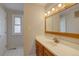 Clean bathroom featuring wood cabinets, a white countertop, and a well-lit mirror at 6272 S Garfield Dr, Centennial, CO 80121