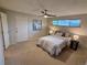 Cozy bedroom featuring a ceiling fan, neutral carpeting, and a white-painted entry door at 6272 S Garfield Dr, Centennial, CO 80121