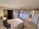 Spacious bedroom with a ceiling fan, carpet floors, and access to the walk-in closet and bathroom at 6272 S Garfield Dr, Centennial, CO 80121
