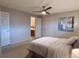Bedroom with carpet floors, ceiling fan, an ensuite bathroom, and a white-painted entry door at 6272 S Garfield Dr, Centennial, CO 80121