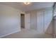 Bedroom featuring carpet, closet space and an entry door to hallway at 6272 S Garfield Dr, Centennial, CO 80121