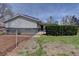 The exterior of the home showing the brick, siding, and privacy hedges at 6272 S Garfield Dr, Centennial, CO 80121