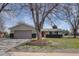 Charming single-story home with a well-manicured lawn, brick accents, and a spacious driveway leading to an attached garage at 6272 S Garfield Dr, Centennial, CO 80121